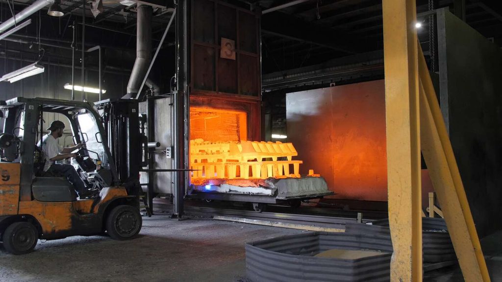 Heat treatment: removing heat treated parts from oven